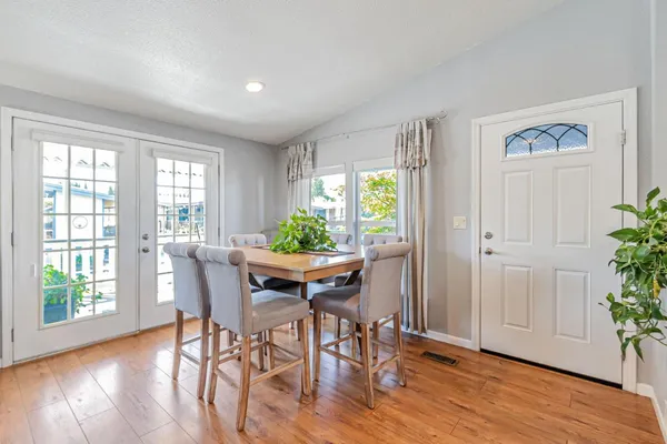 a view of a dining room with furniture and wooden floor