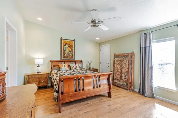 a bedroom with a bed and a chandelier