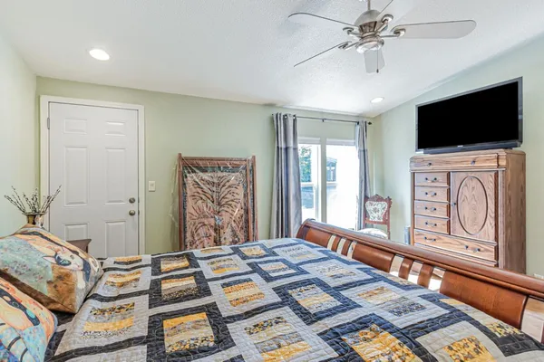 a bedroom with furniture and flat screen tv