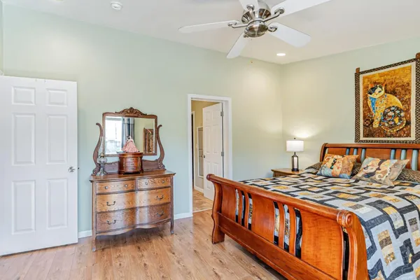 a bedroom with furniture and wooden floor