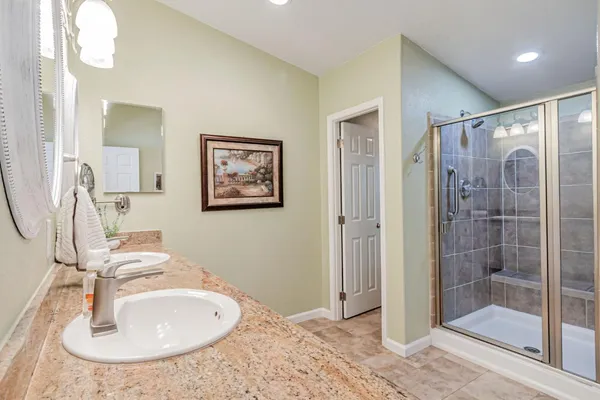 a bathroom with a sink double vanity and shower