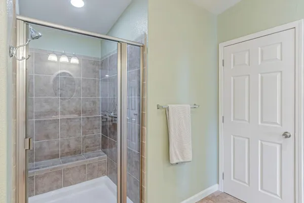 a bathroom with a glass shower door