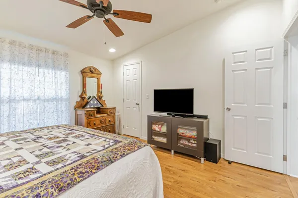 a bedroom with a bed and a flat screen tv