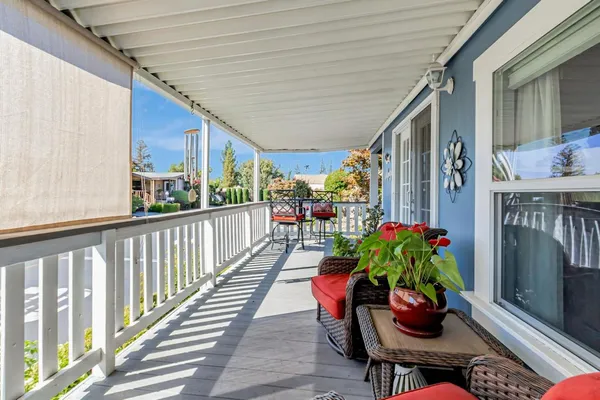 a balcony with furniture and flowers