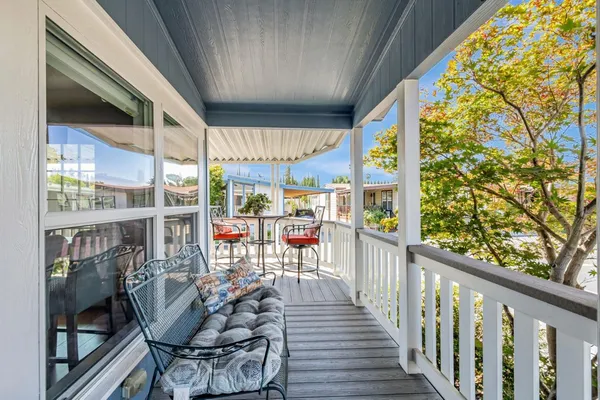 a view of a chairs and table in a balcony