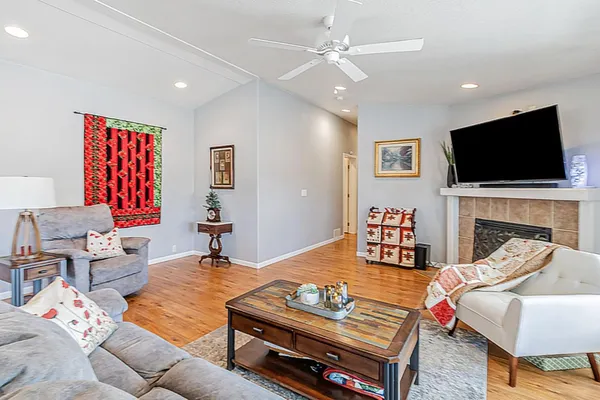 a living room with furniture a flat screen tv and a fireplace