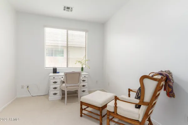 a living room with furniture a air conditioner and a window