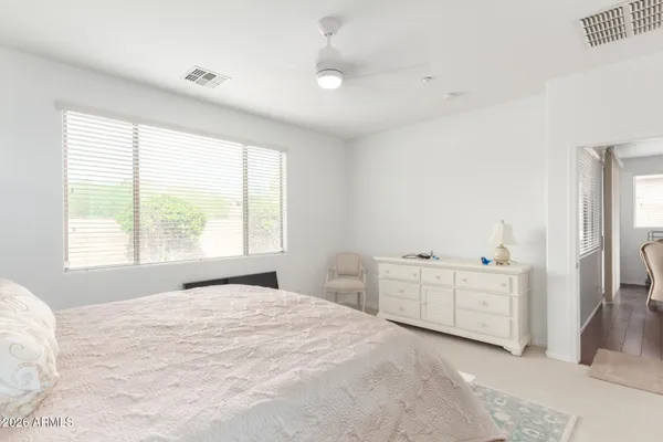 a bedroom with a bed and a dresser
