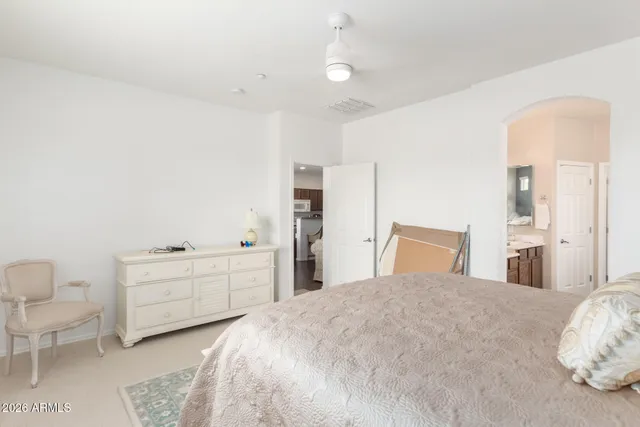 a spacious bedroom with a bed and a cabinets