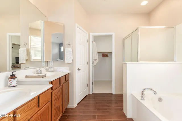 a bathroom with a sink a mirror and a bathtub