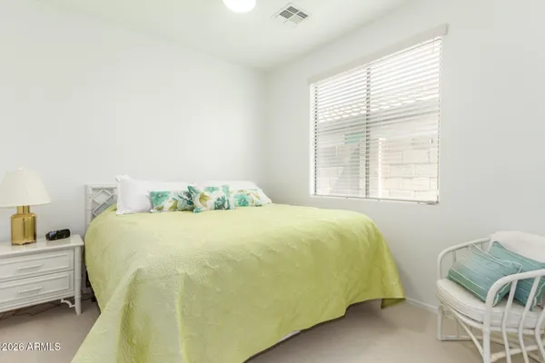 a bedroom with a bed and window