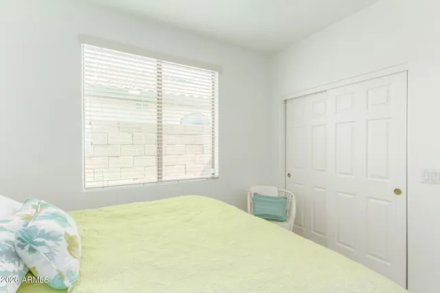 a bedroom with a bed and a window