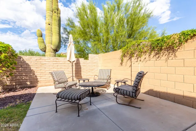 a view of a patio with couple of chairs and couches in the patio