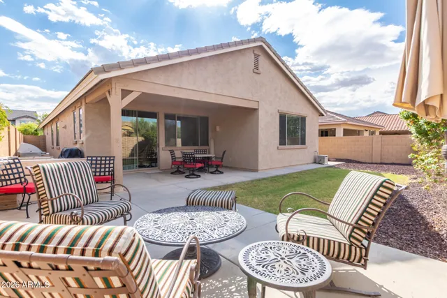 a view of a patio with couches table and chairs and potted plants