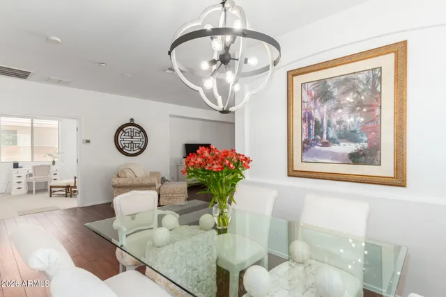 a living room with furniture chandelier and a mirror