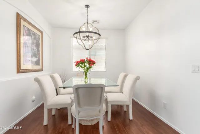 a view of a dining room with furniture wooden floor and chandelier