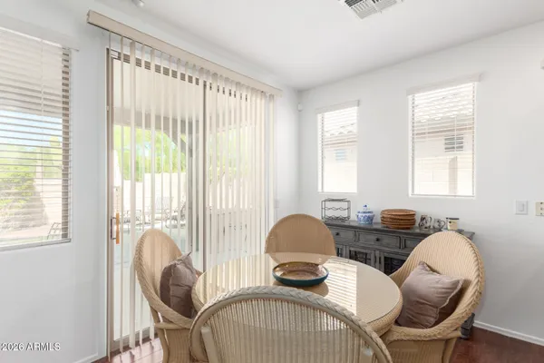 a view of a dining room with furniture and windows