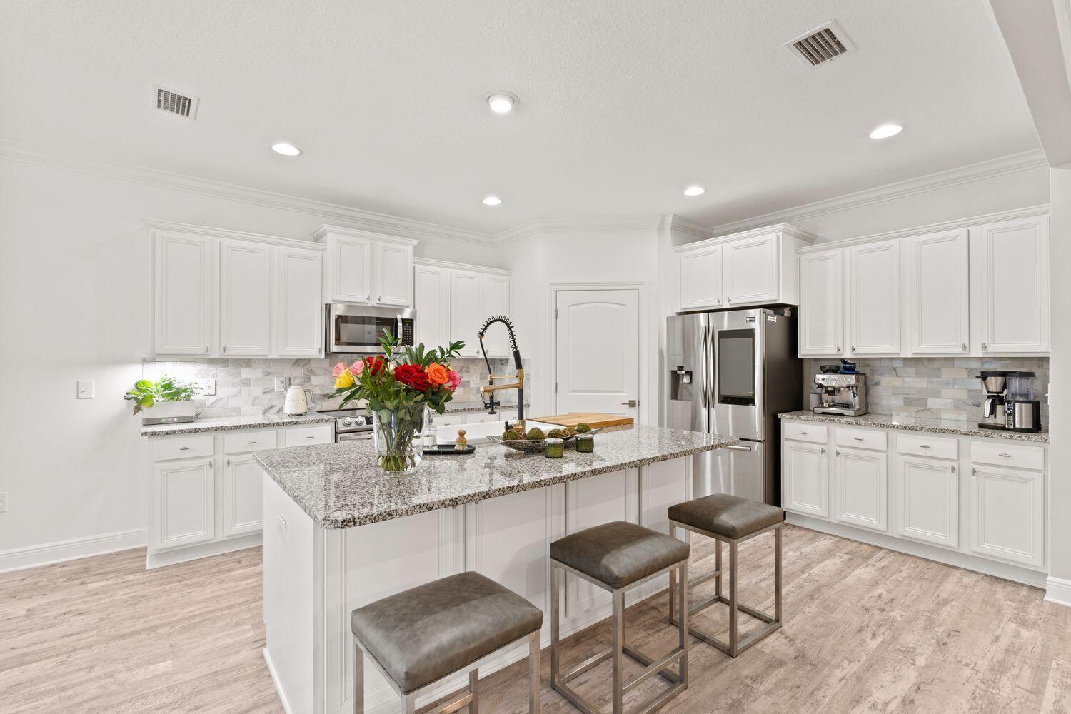 40 Bryant Road, Unit LOT 84 Santa Rosa Beach, FL 32459 - Photo 11 of 42 a kitchen with refrigerator and chairs