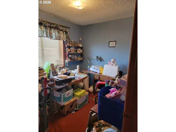a living room with furniture and a book shelf