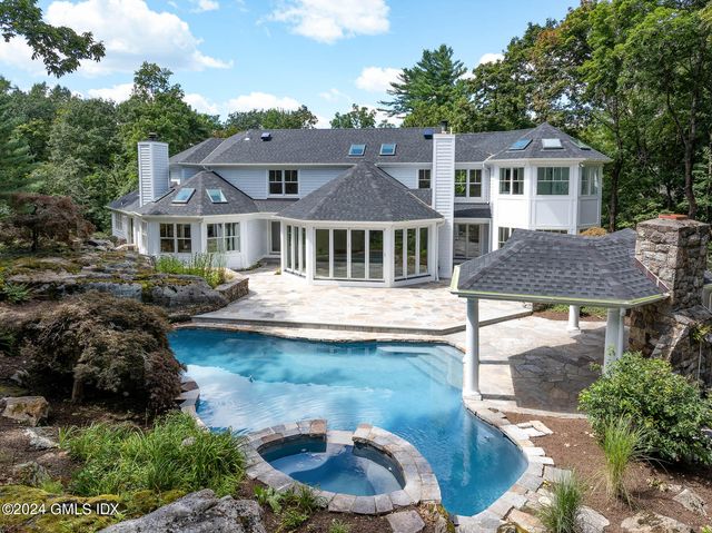 a front view of a house with a yard table and chairs