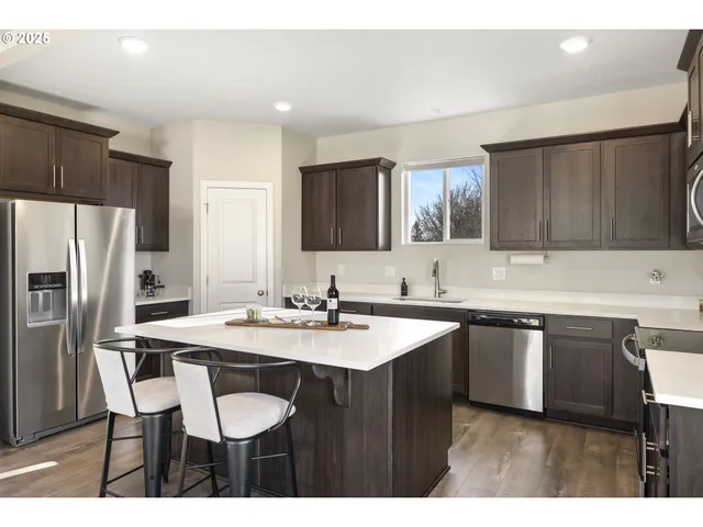 a kitchen with a sink cabinets and refrigerator