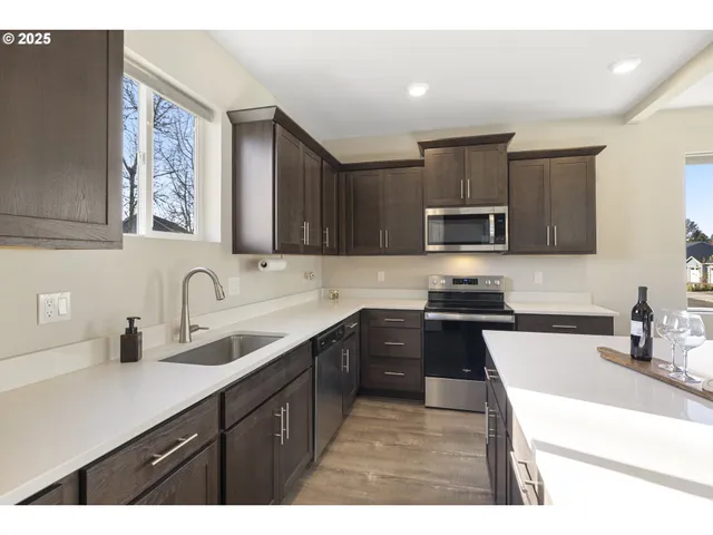 a kitchen with a sink stove top oven and microwave