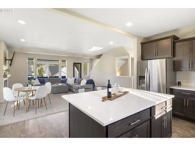 a kitchen with a sink refrigerator and dining table