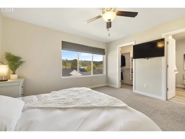 a bedroom with a large bed and a window