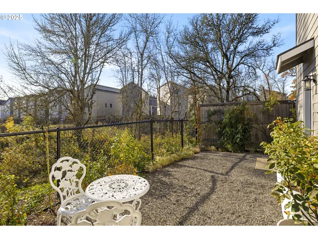 a view of a house with a big yard and large trees