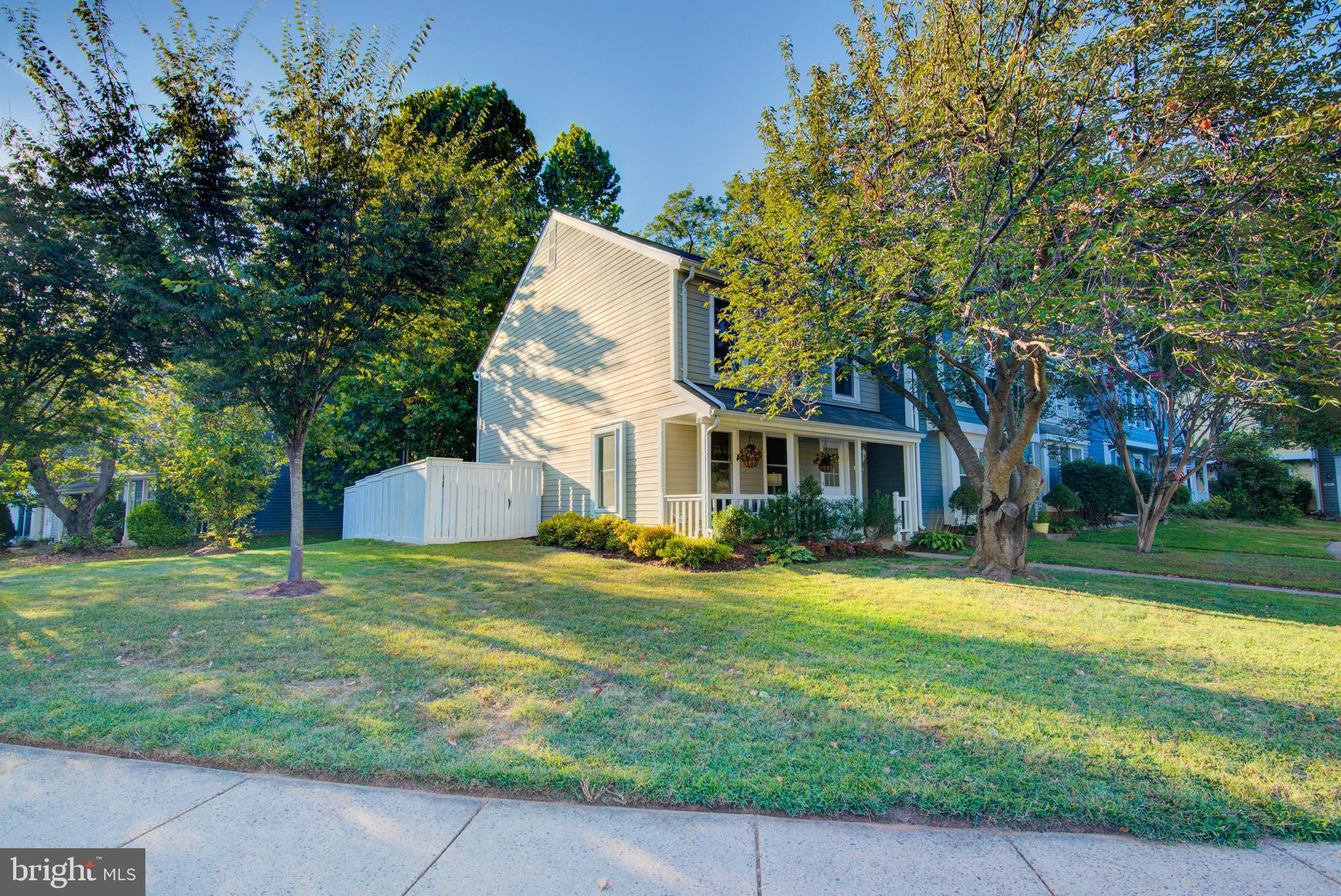 1551 Poplar Grove Drive Reston, VA 20194 - Photo 1 of 24 a view of a house with a big yard and large trees