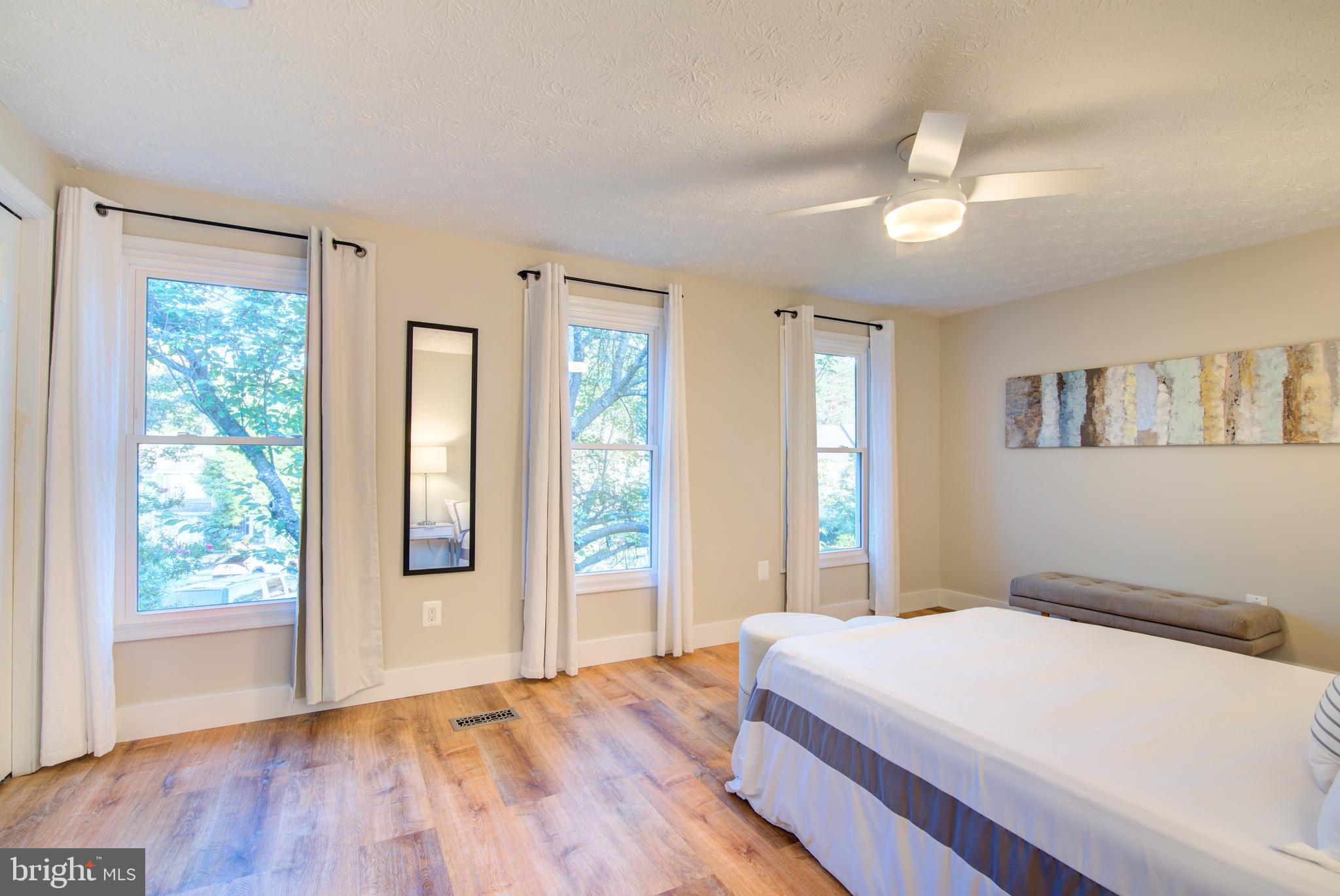 1551 Poplar Grove Drive Reston, VA 20194 - Photo 10 of 24 a bedroom with a large bed and a window