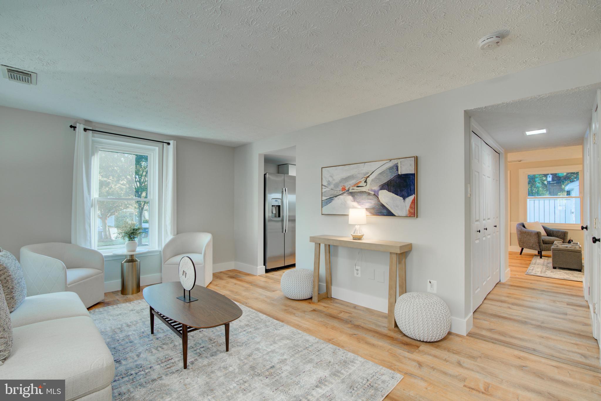 1551 Poplar Grove Drive Reston, VA 20194 - Photo 3 of 24 a living room with furniture a dining table and a wooden floor