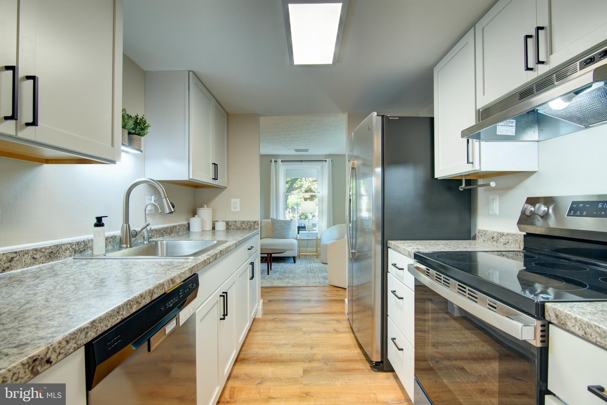 1551 Poplar Grove Drive Reston, VA 20194 - Photo 5 of 24 a kitchen with a sink stove and cabinets
