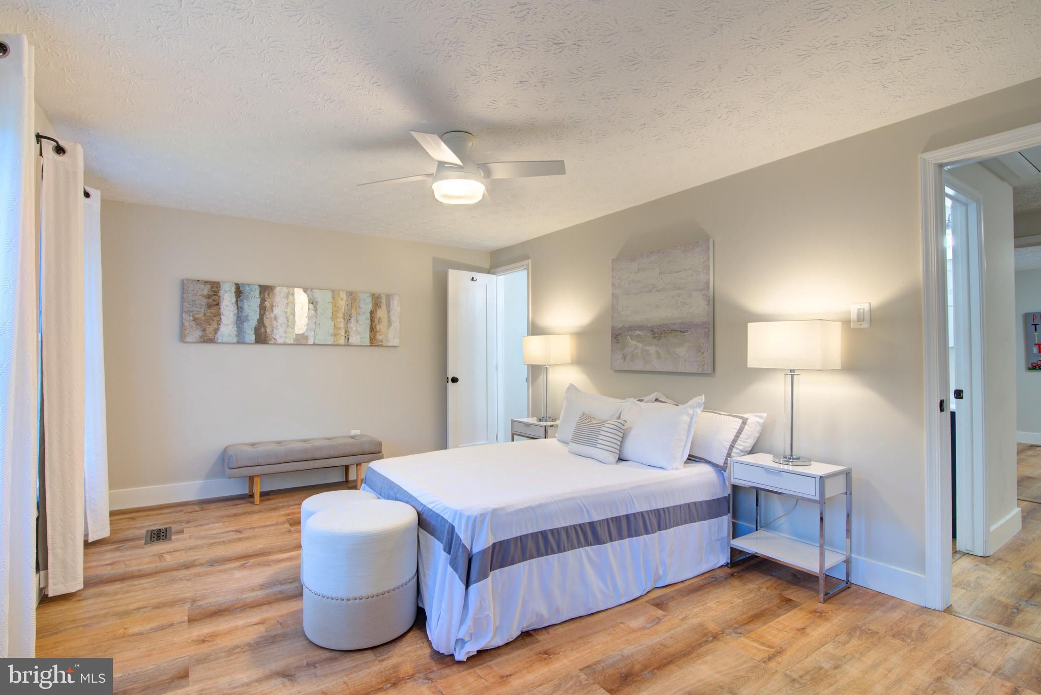 1551 Poplar Grove Drive Reston, VA 20194 - Photo 9 of 24 a spacious bedroom with a bed and wooden floor