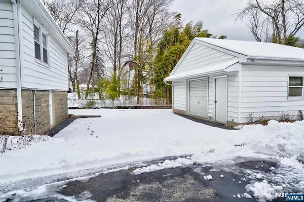 a view of a house with a yard covered in snow