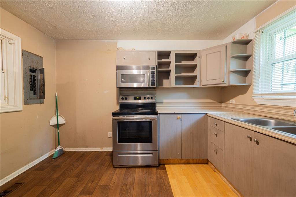 3838 Old Gordon Road Northwest Atlanta, GA 30336 - Photo 9 of 23 a kitchen with stainless steel appliances a stove and a refrigerator