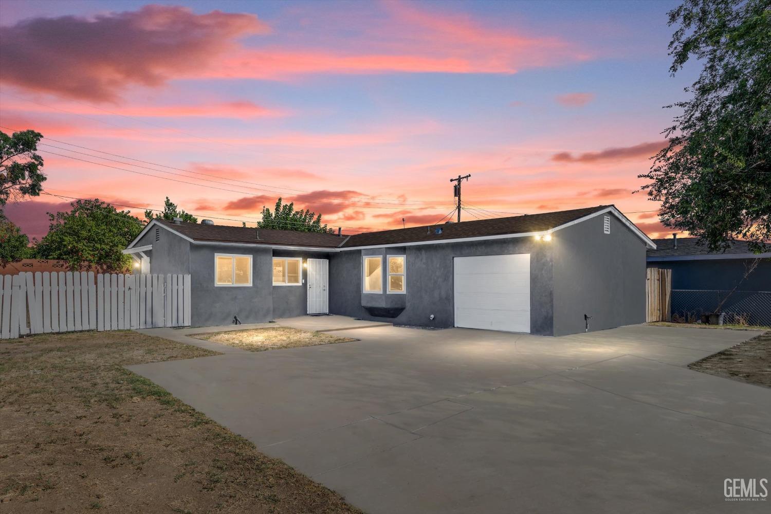 Undisclosed Address Bakersfield, CA 93306 - Photo 1 of 26 a front view of a house with a yard and garage