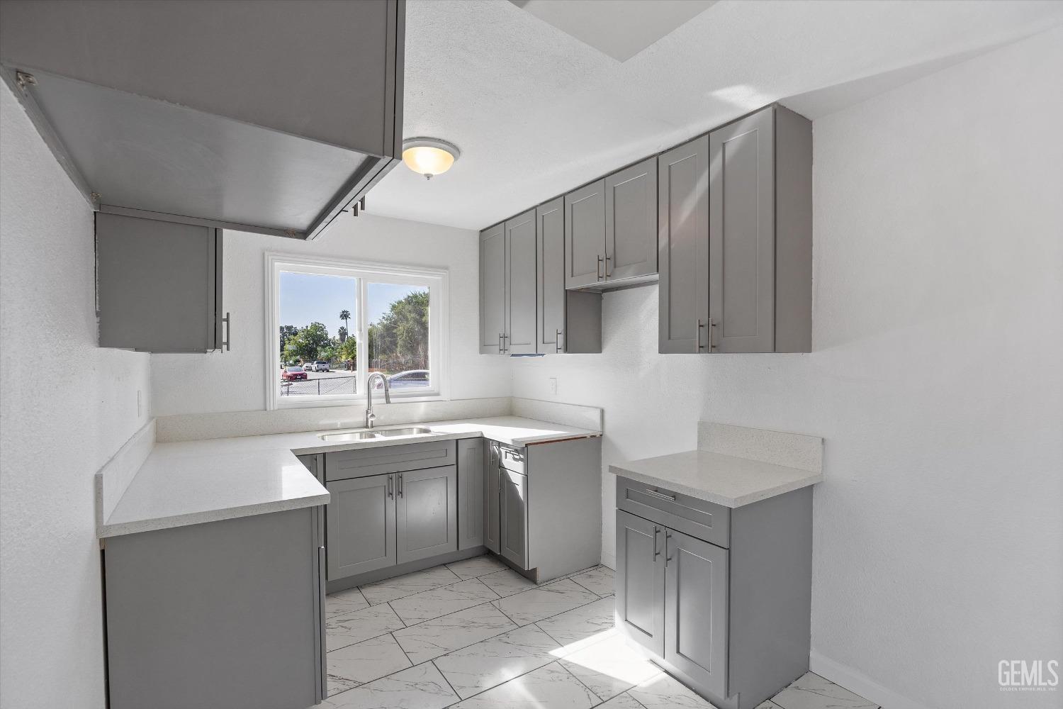 Undisclosed Address Bakersfield, CA 93306 - Photo 11 of 26 a kitchen with a sink a stove and cabinets