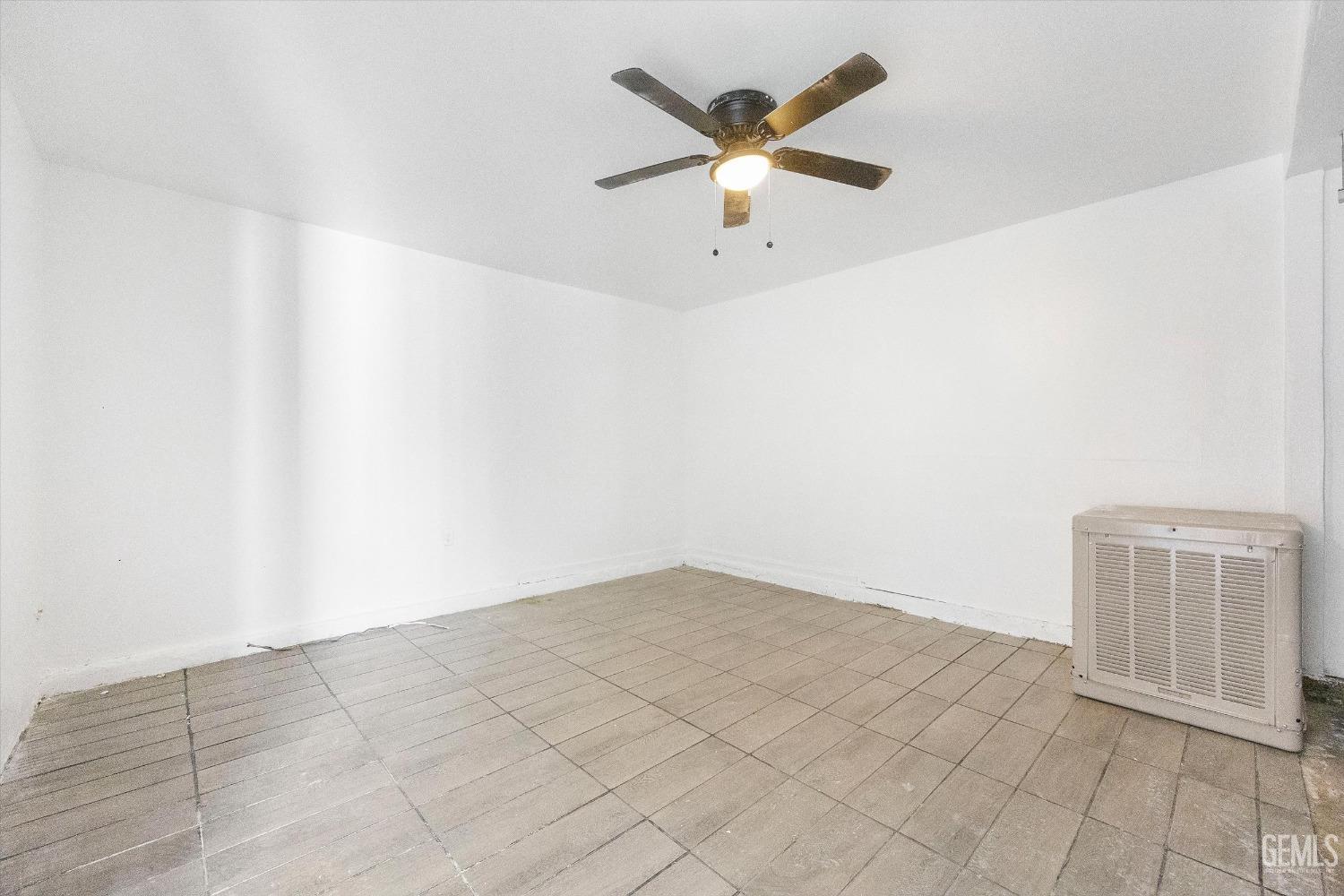 Undisclosed Address Bakersfield, CA 93306 - Photo 21 of 26 an empty room with a ceiling fan and wooden floor