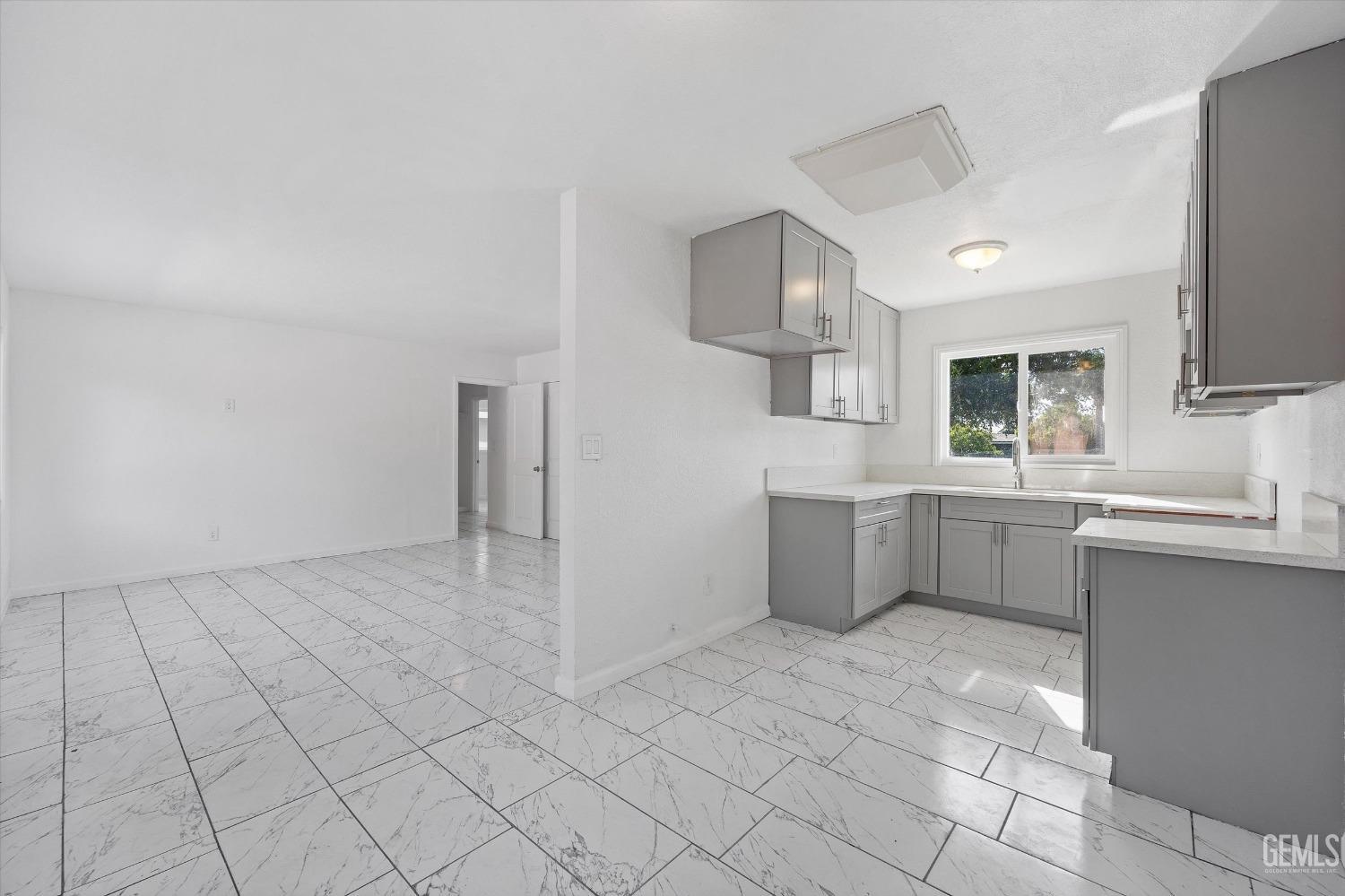 Undisclosed Address Bakersfield, CA 93306 - Photo 10 of 26 a kitchen with a sink a counter top space cabinets and stainless steel appliances