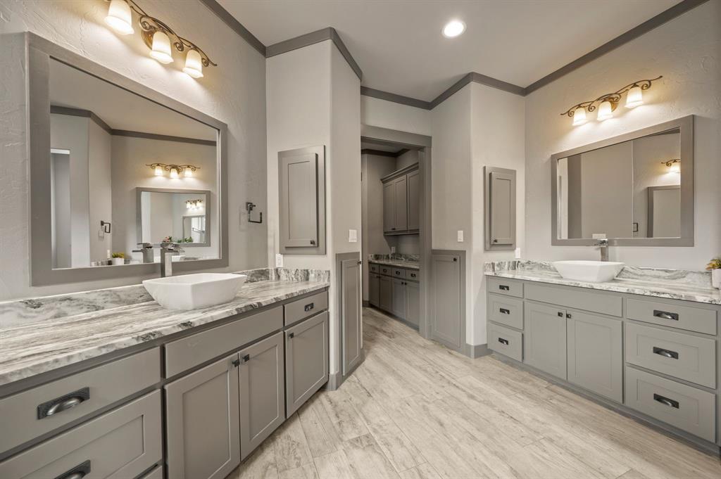 248 Howard Road Valley View, TX 76272 - Photo 21 of 40 a spacious bathroom with a granite countertop sink mirror and double