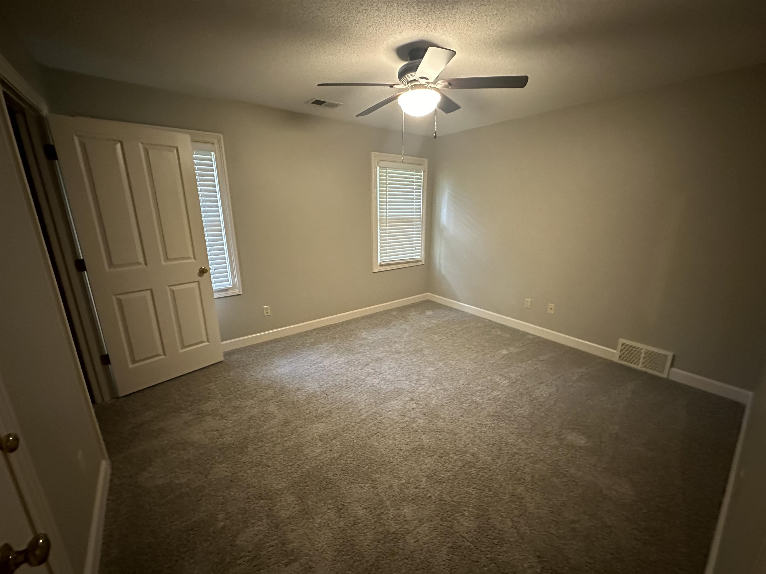 482 Brook Ridge Circle Memphis, TN 38018 - Photo 14 of 17 an empty room with windows and fan