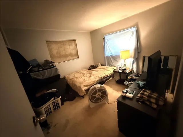 a bedroom with bed and window