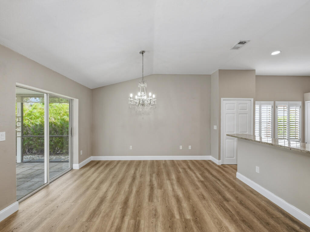 3650 Kent Drive Naples, FL 34112 - Photo 11 of 17 a view of livingroom with hardwood floor and window
