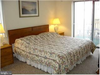 0 Edward Taylor Road, Unit 101 Ocean City, MD 21842 - Photo 5 of 7 a large bed sitting in a bedroom next to a window