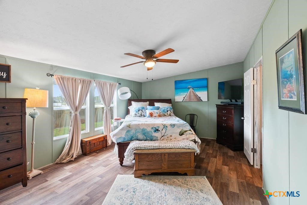 239 Allen M Parks Drive Rockport, TX 78382 - Photo 7 of 29 a bed room with a bed and a chandelier