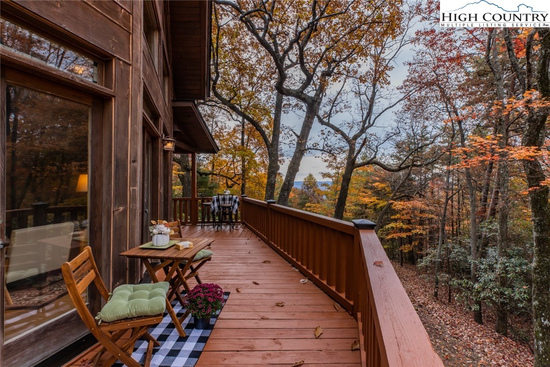 899 Bobcat Mountain Road Purlear, NC 28665 - Photo 14 of 50 a balcony with wooden floor and outdoor seating