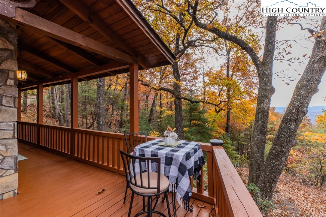 899 Bobcat Mountain Road Purlear, NC 28665 - Photo 16 of 50 a patio with wooden floor and outdoor seating