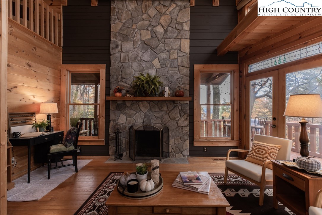 899 Bobcat Mountain Road Purlear, NC 28665 - Photo 20 of 50 a living room with furniture fireplace and a fireplace