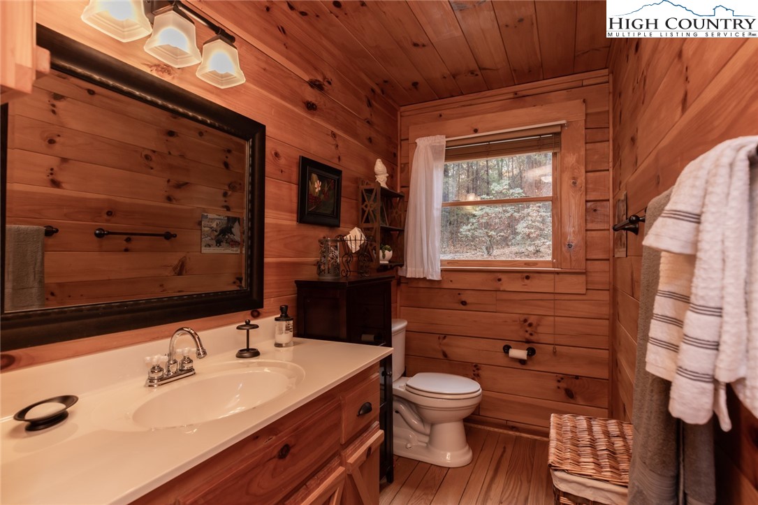 899 Bobcat Mountain Road Purlear, NC 28665 - Photo 26 of 50 a bathroom with a sink mirror vanity and toilet